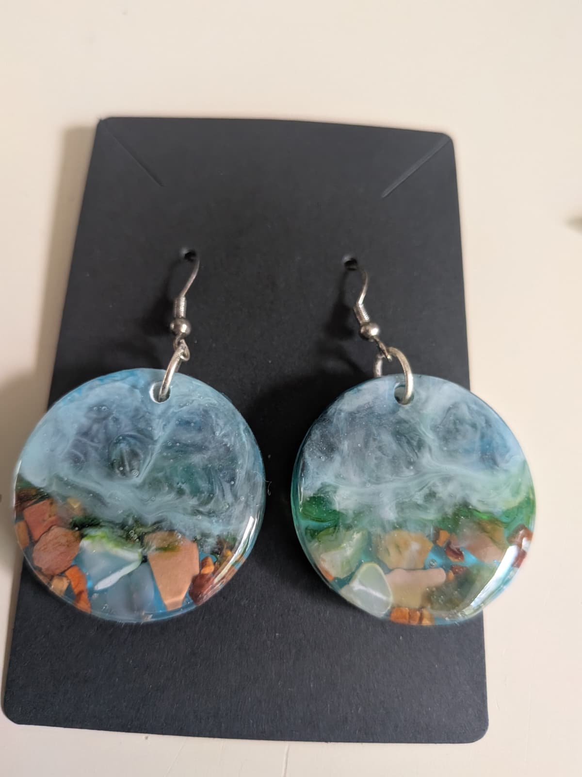 set of pendant, earrings and keychain with a sea theme