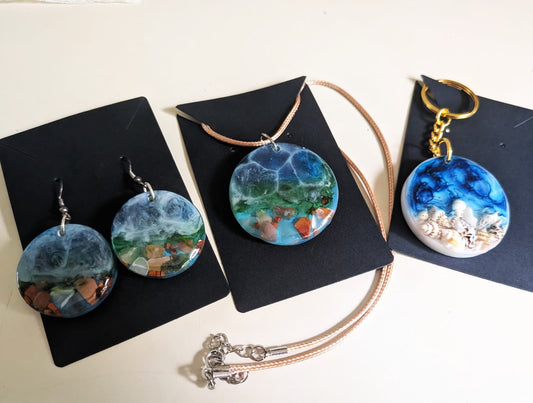 set of pendant, earrings and keychain with a sea theme
